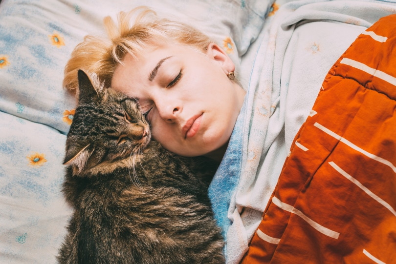 cat sleeping with owner