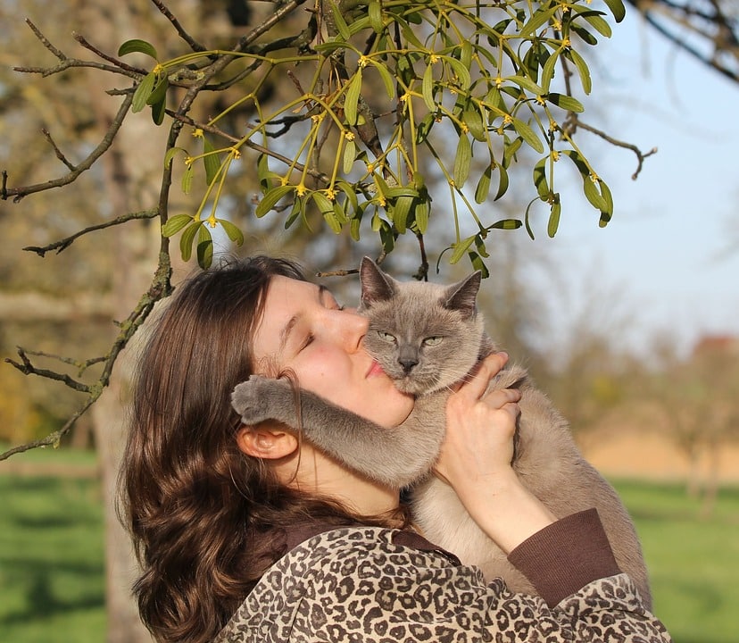 woman kissing her cat